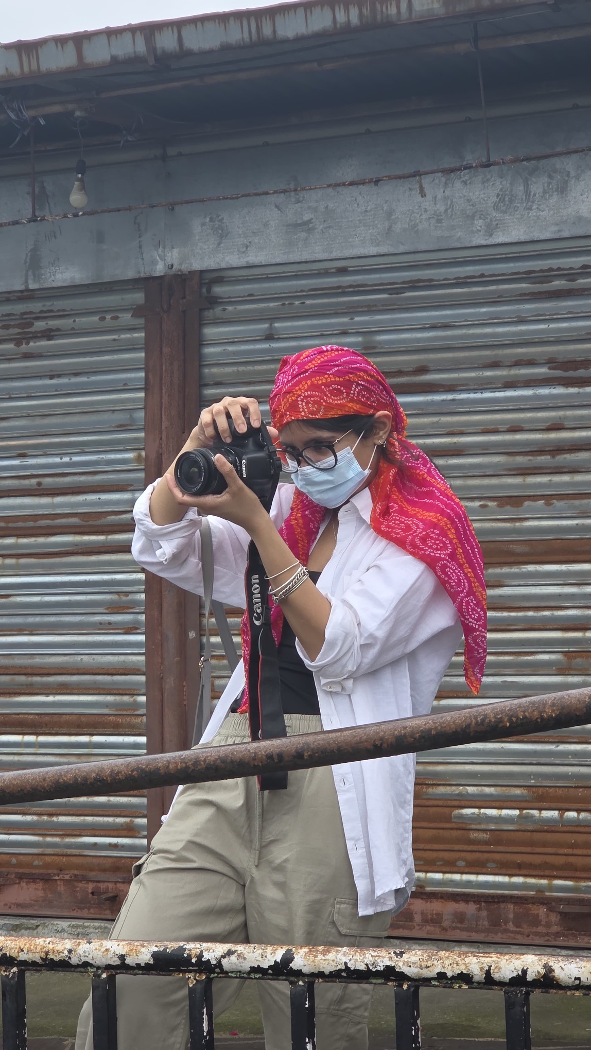 The image shows author trying to capture some story through her lens. It was a candid.